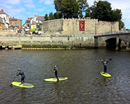Stand up paddle boarding through Cardigan town