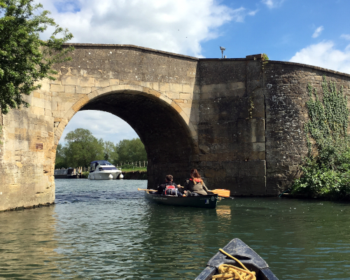 Canoeing through ancient bridge