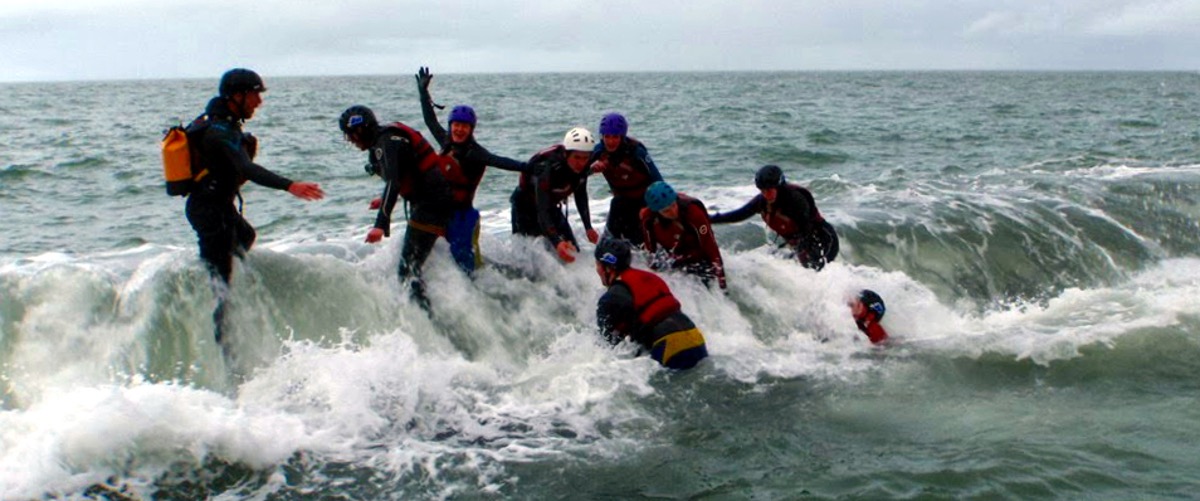 Coasteering Cardigan with wave crashing 
