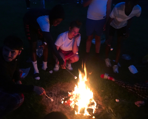 Toasting marshmallows in camp